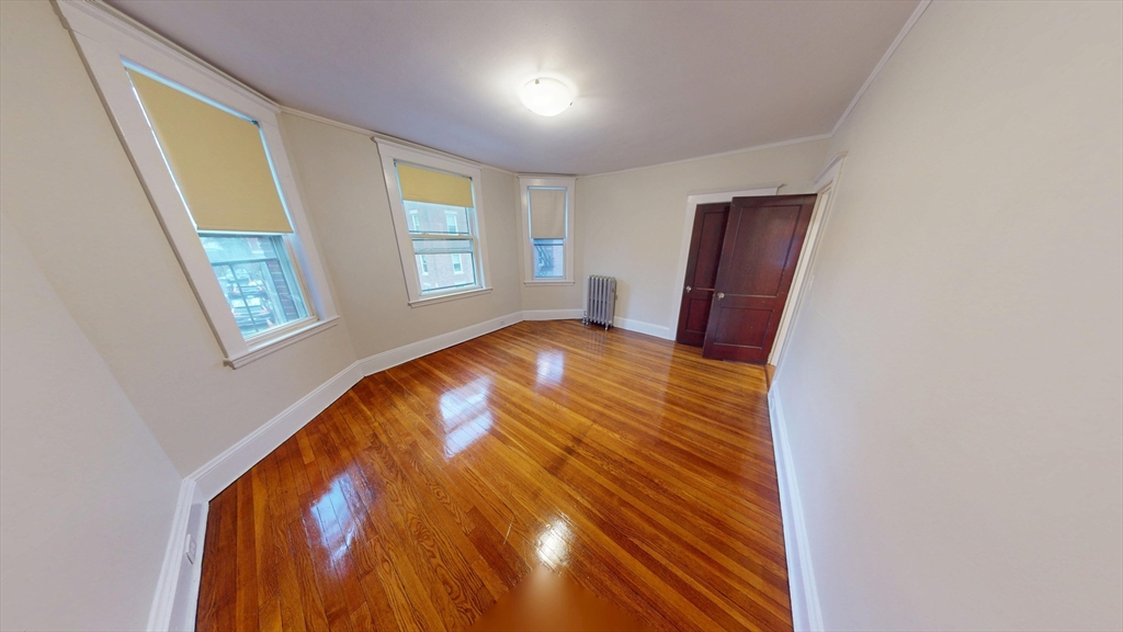 7 Scottfield Road, Unit 8 Boston, MA 02134 - Photo 1 of 6 a view of room with wooden floor and staircase