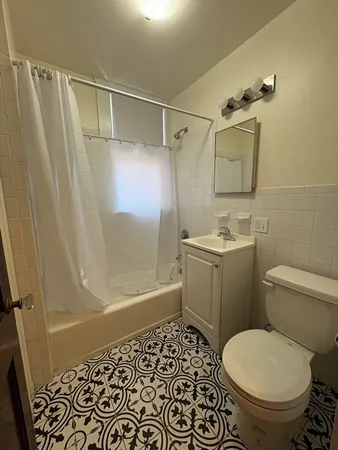 a bathroom with a toilet and shower