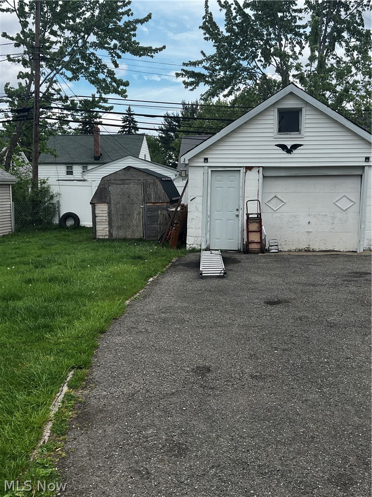 19529 Libby Road Maple Heights, OH 44137 - Photo 13 of 13 Garage with a yard