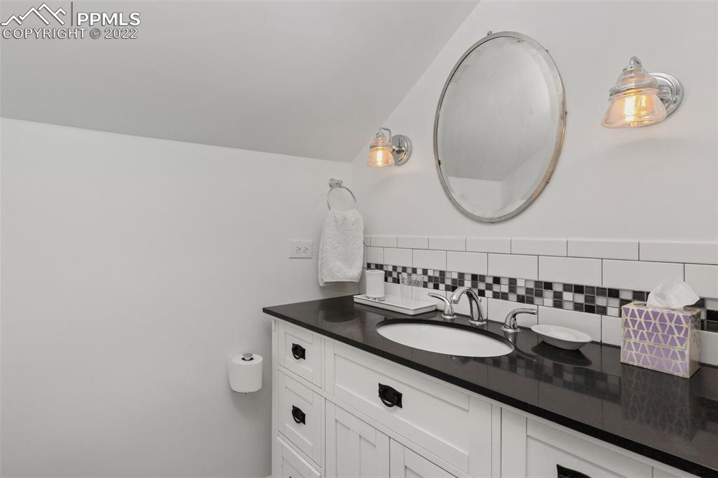 2073 North Perry Park Road Sedalia, CO 80135 - Photo 15 of 40 a bathroom with a sink and a mirror