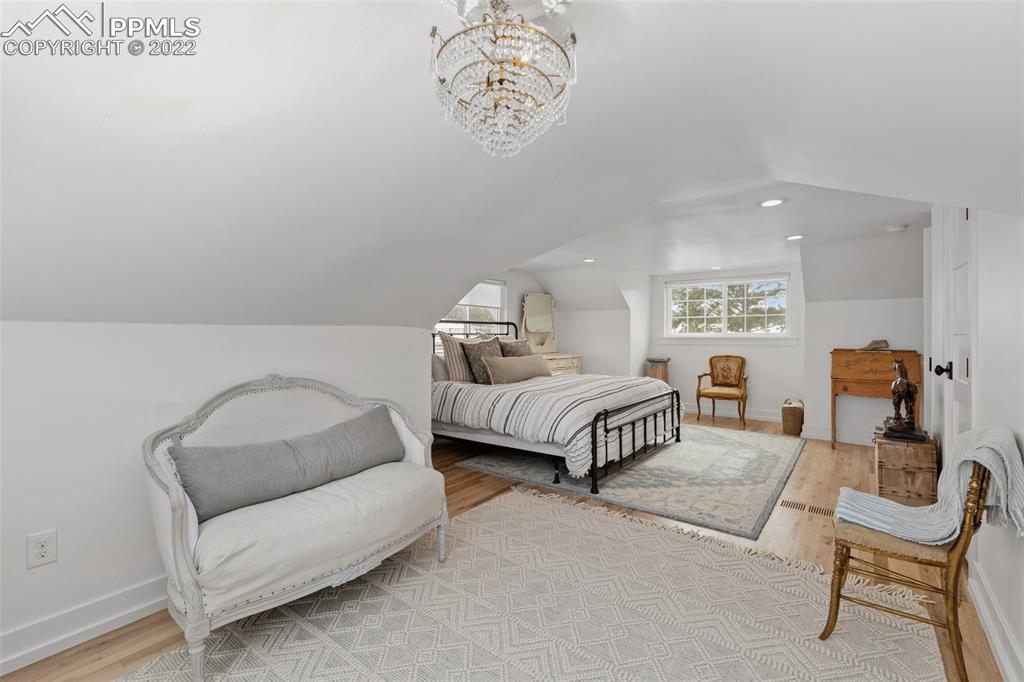 2073 North Perry Park Road Sedalia, CO 80135 - Photo 17 of 40 a bedroom with a bed and a couch