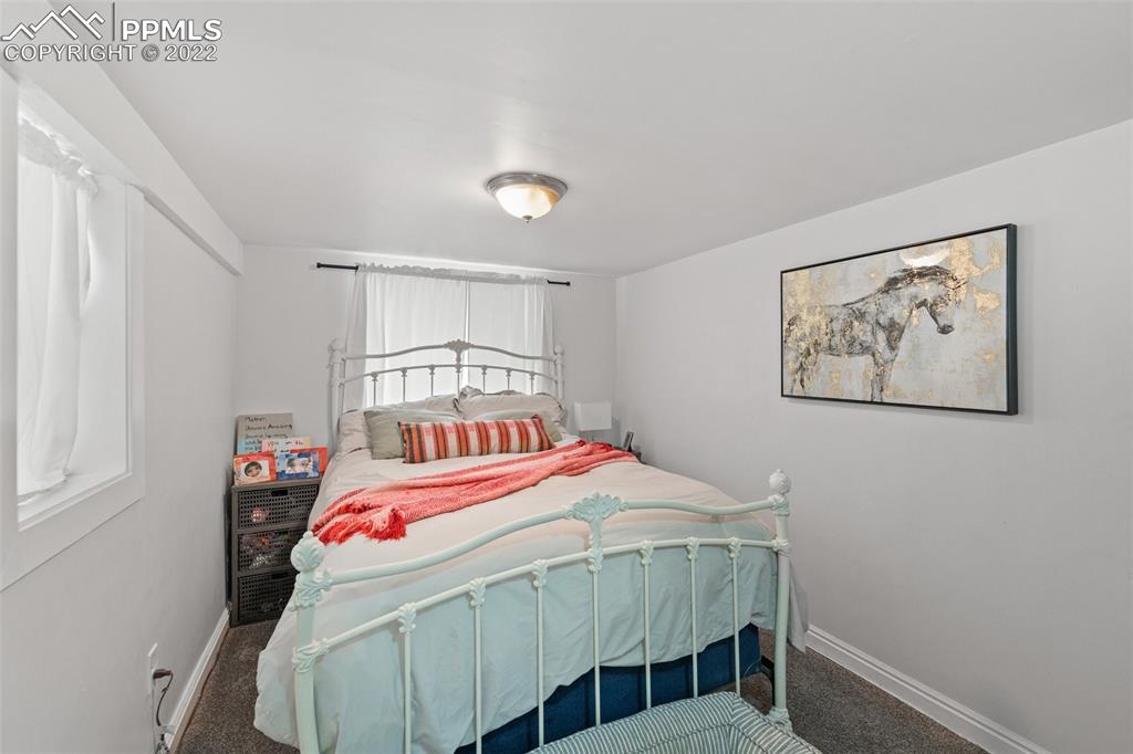 2073 North Perry Park Road Sedalia, CO 80135 - Photo 24 of 40 a bedroom with a bed a baby and a closet