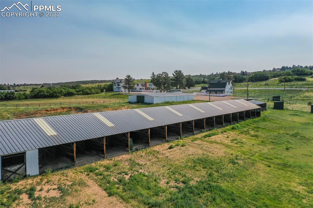 2073 North Perry Park Road Sedalia, CO 80135 - Photo 32 of 40 a view of a house with pool and a yard