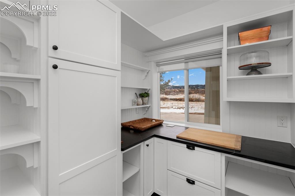 2073 North Perry Park Road Sedalia, CO 80135 - Photo 7 of 40 a kitchen with a refrigerator and a window