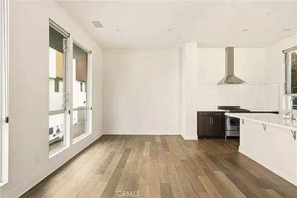 a view of kitchen with wooden floor and electronic appliances