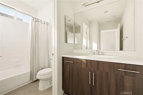 a bathroom with a double vanity sink toilet and shower