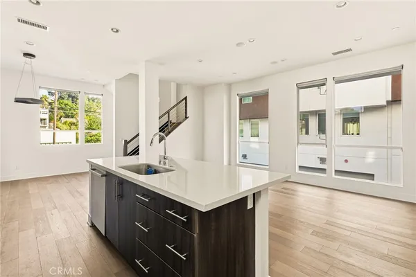 a kitchen with a sink stove and cabinets