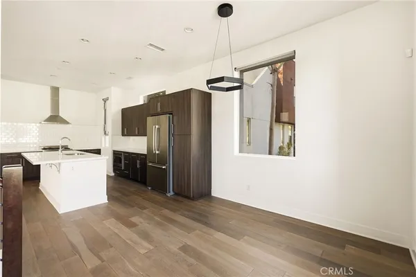 a kitchen with stainless steel appliances a refrigerator and a stove top oven