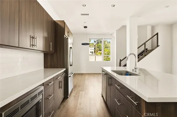 a kitchen with sink cabinets and wooden floor