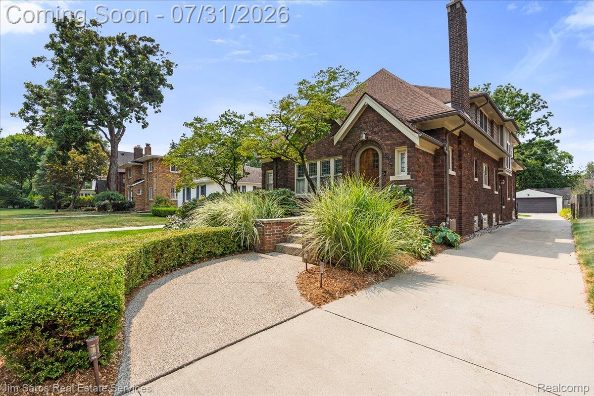 637 Washington Road Grosse Pointe, MI 48230 - Photo 40 of 40 Brick residence featuring a pitched roof, prominent chimney, and multiple windows