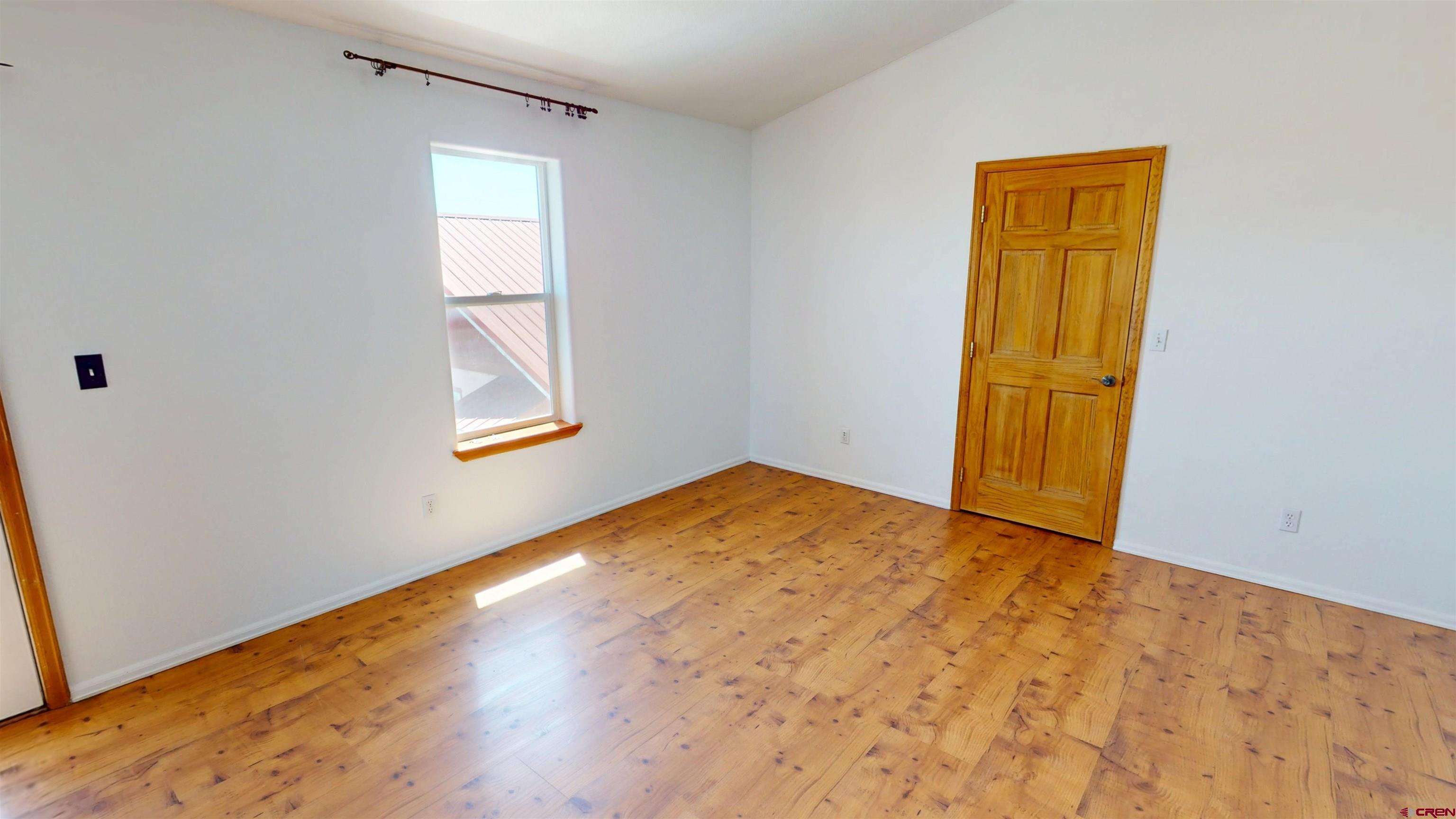 309 Main Street Romeo, CO 81148 - Photo 32 of 44 a view of empty room with wooden floor and fan