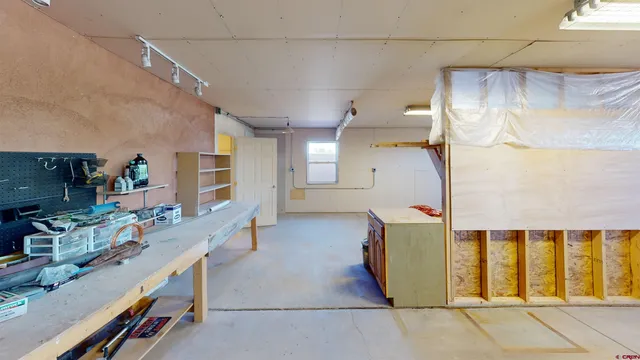 a bed sitting in a bedroom next to a white wall