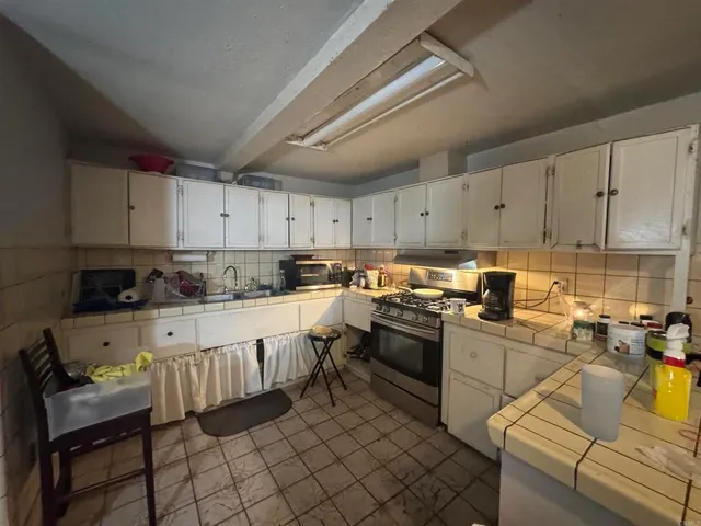 a kitchen with cabinets appliances and a sink