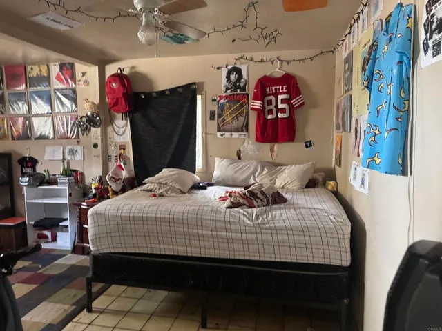 a bedroom with a bed and window