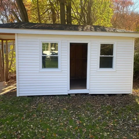 a view of a house with a yard and garage