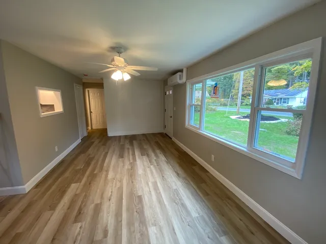wooden floor in an empty room with a window
