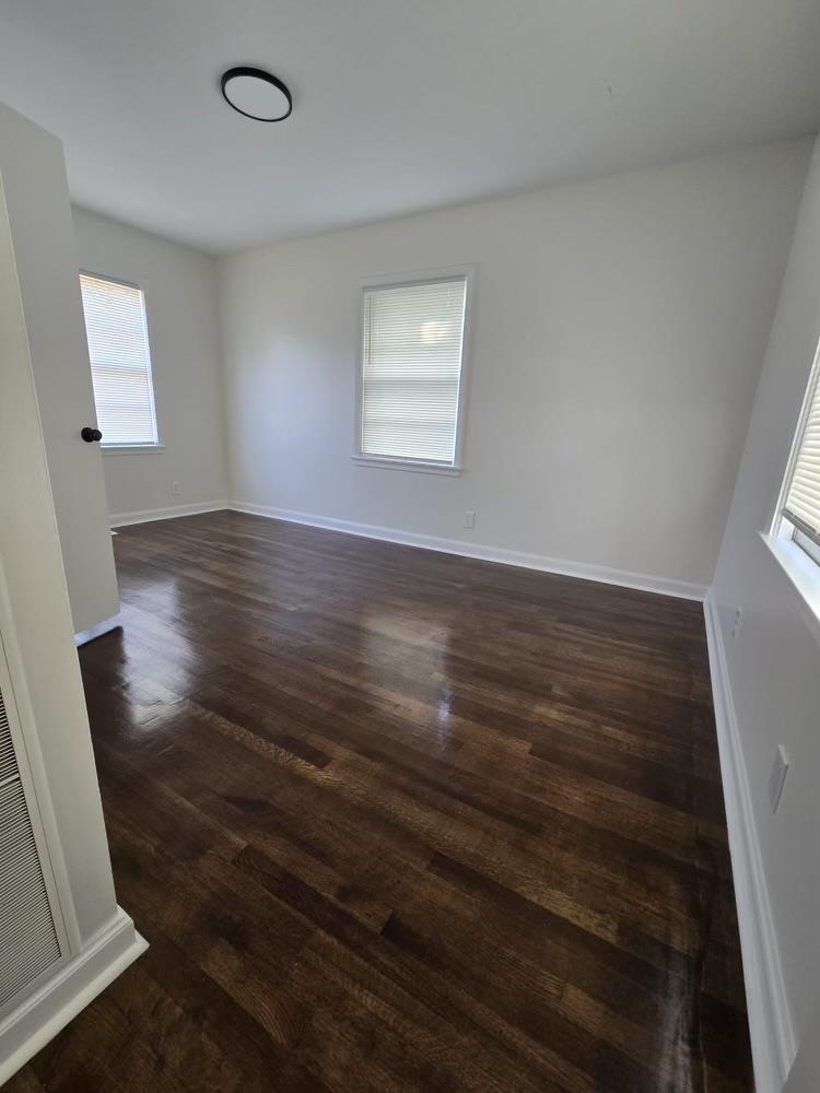 4491 Raleigh Millington Road Memphis, TN 38128 - Photo 11 of 16 Primary bedroom has a wealth of natural light and wood flooring.