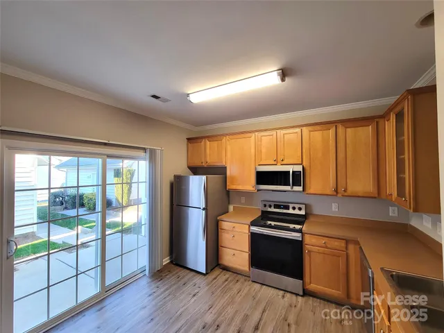 a kitchen with granite countertop stainless steel appliances and wooden cabinets
