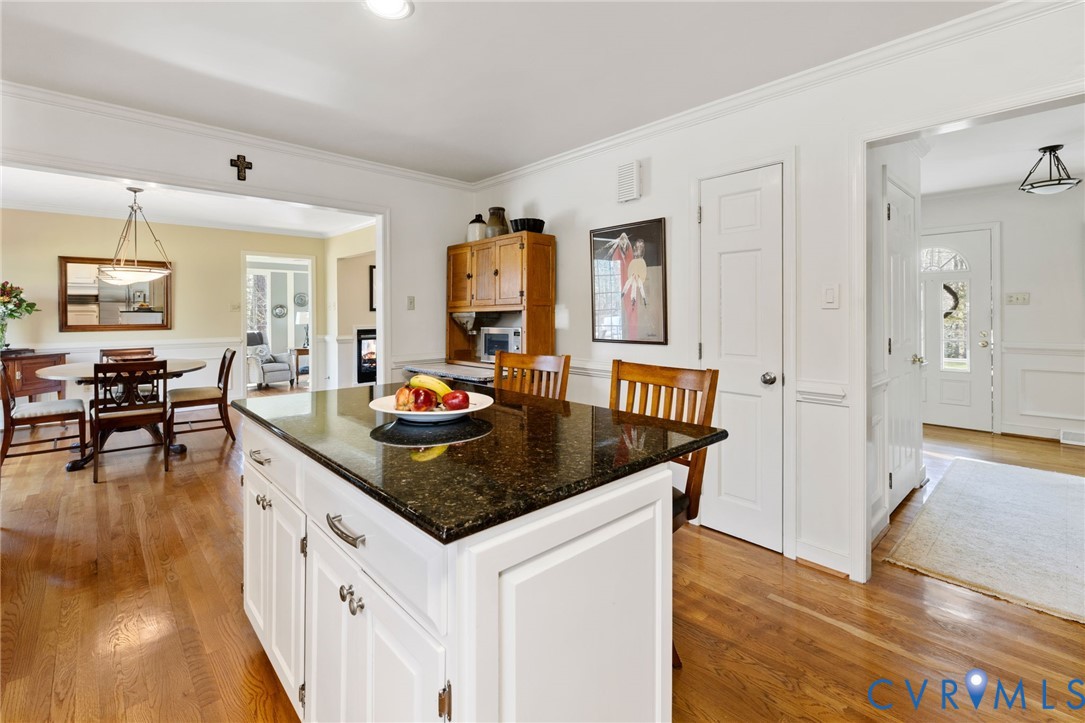 1530 Greenberry Road Powhatan, VA 23139 - Photo 21 of 49 a kitchen with granite countertop a table and chairs in it