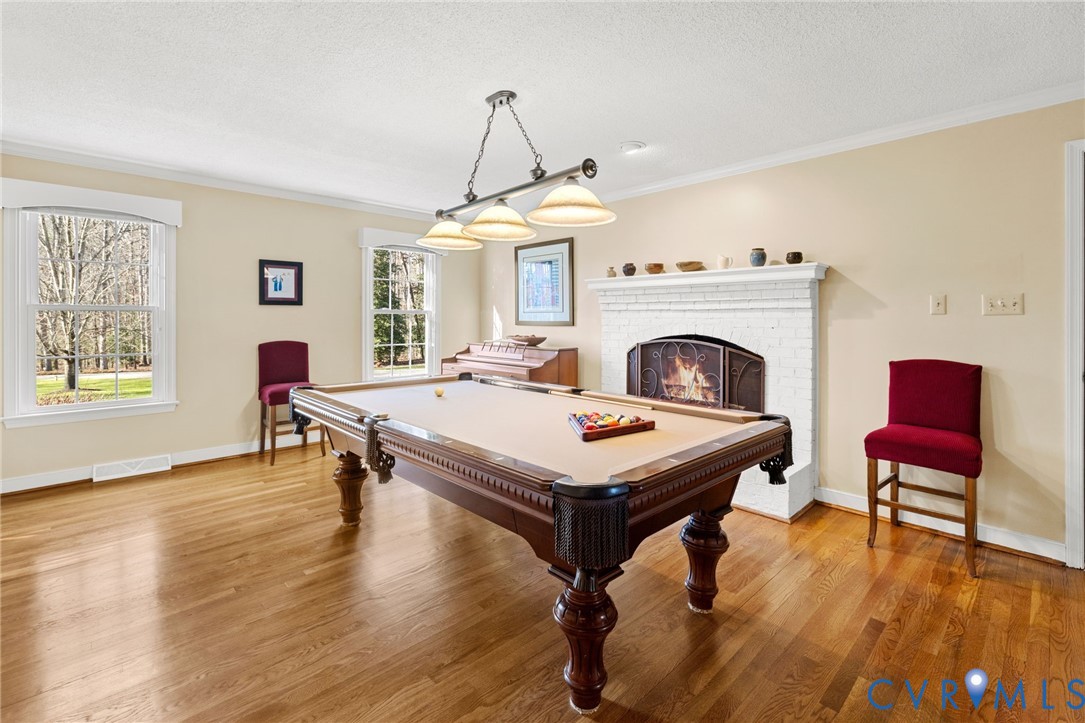 1530 Greenberry Road Powhatan, VA 23139 - Photo 22 of 49 a view of a livingroom with furniture a fireplace and wooden floor