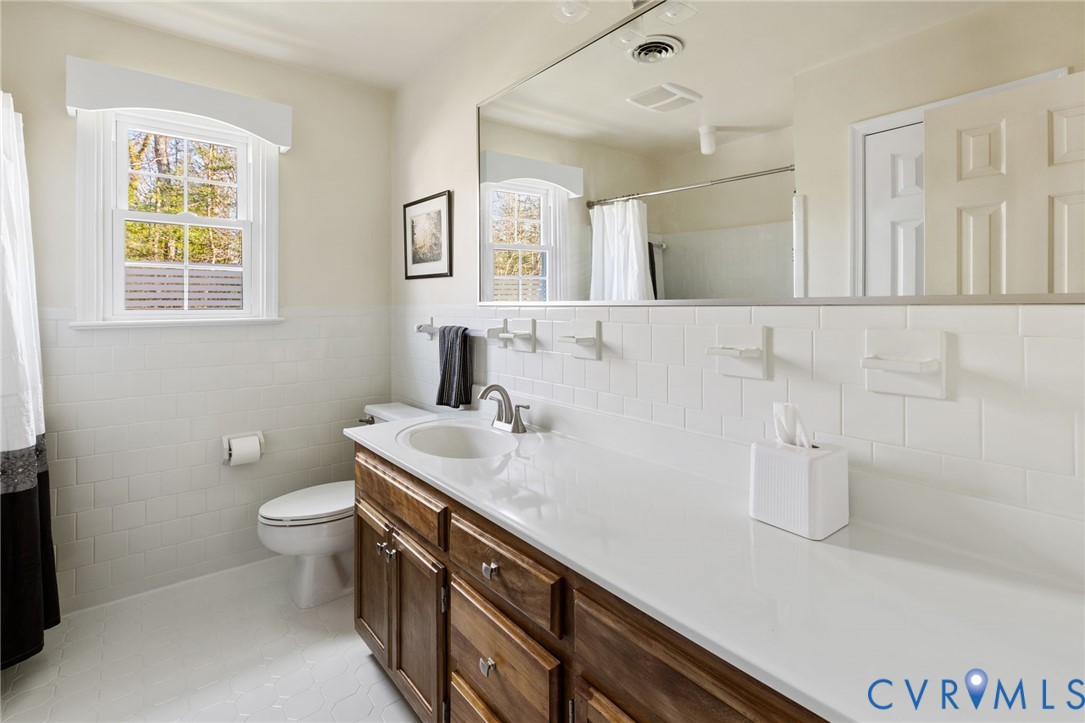 1530 Greenberry Road Powhatan, VA 23139 - Photo 29 of 49 a bathroom with a sink a toilet and a mirror