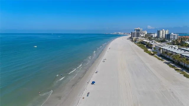 an aerial view of a house with a garden and lake view