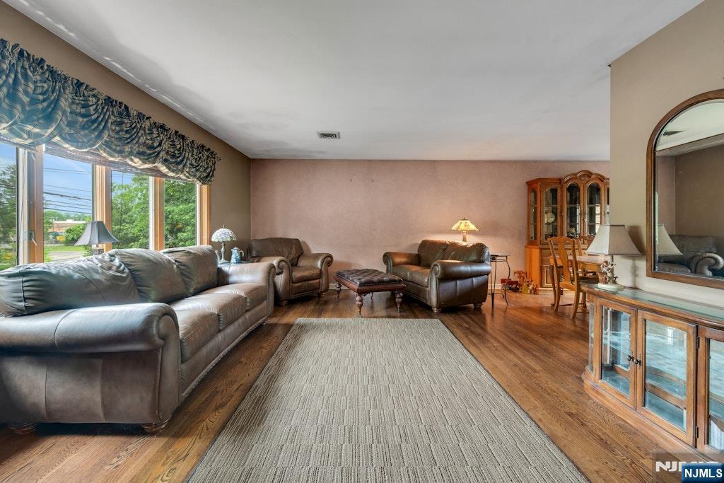 185 Ratzer Road Wayne, NJ 07470 - Photo 12 of 36 a living room with furniture flat screen tv and a large window