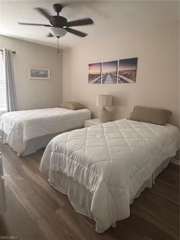 a bedroom with a bed and painting on the wall