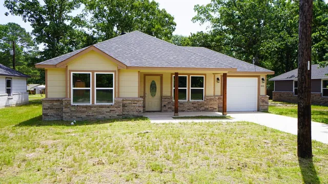 a view of a house with a yard and outdoor space