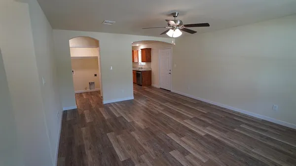 wooden floor in an empty room with a window