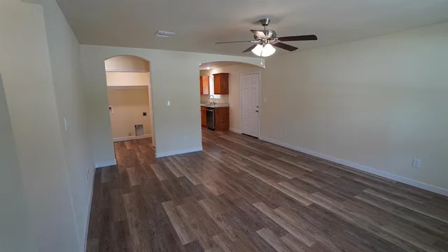 wooden floor in an empty room with a window
