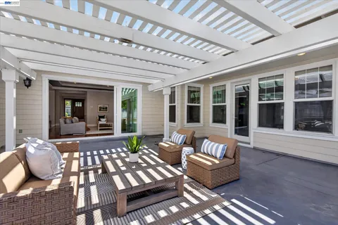 a living room with furniture and floor to ceiling windows