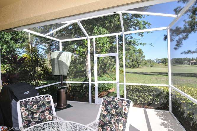 4688 Fairloop Lehigh Acres, FL 33973 - Photo 12 of 24 a view of a balcony with chair and wooden floor
