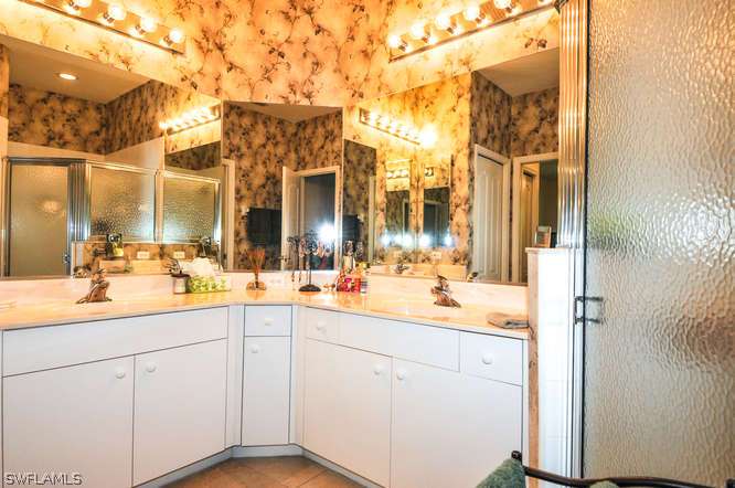 4688 Fairloop Lehigh Acres, FL 33973 - Photo 15 of 24 a bathroom with a sink and a mirror
