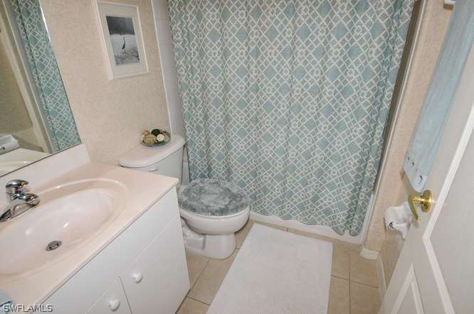4688 Fairloop Lehigh Acres, FL 33973 - Photo 17 of 24 a bathroom with a sink and toilet