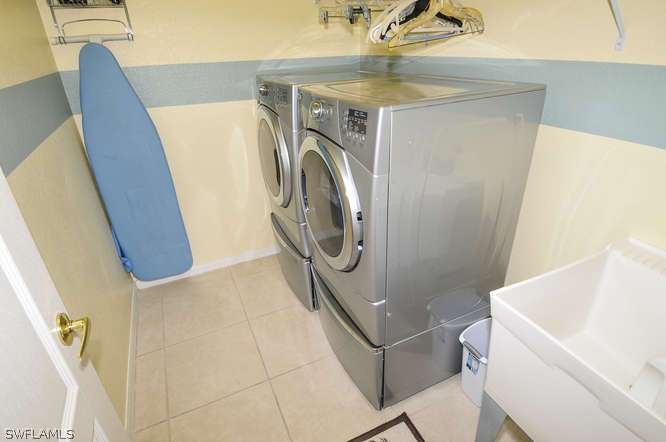 4688 Fairloop Lehigh Acres, FL 33973 - Photo 18 of 24 a utility room with a sink washer and dryer