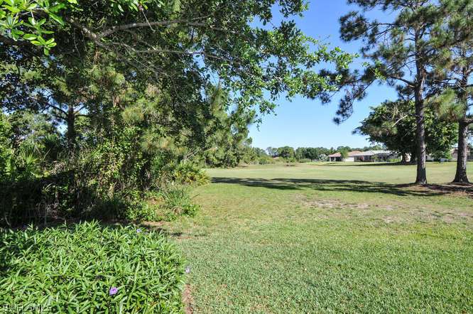 4688 Fairloop Lehigh Acres, FL 33973 - Photo 19 of 24 a view of a green yard