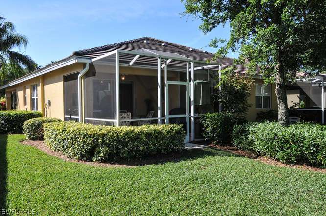 4688 Fairloop Lehigh Acres, FL 33973 - Photo 20 of 24 a front view of a house with a yard