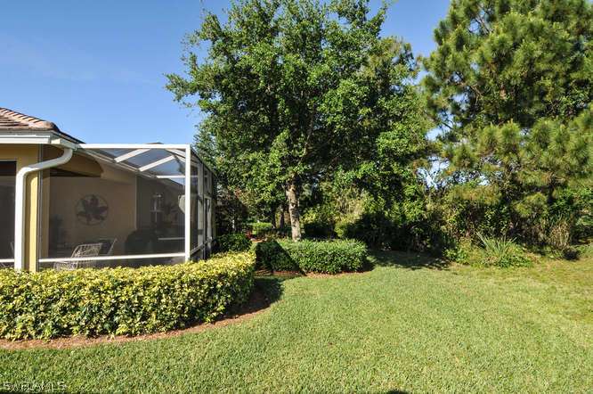 4688 Fairloop Lehigh Acres, FL 33973 - Photo 21 of 24 a view of a house with a small yard and a garden