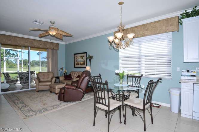 4688 Fairloop Lehigh Acres, FL 33973 - Photo 6 of 24 a living room with furniture and a chandelier