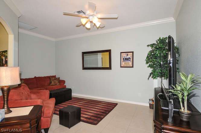 4688 Fairloop Lehigh Acres, FL 33973 - Photo 10 of 24 a living room with furniture flowerpot and a potted plant