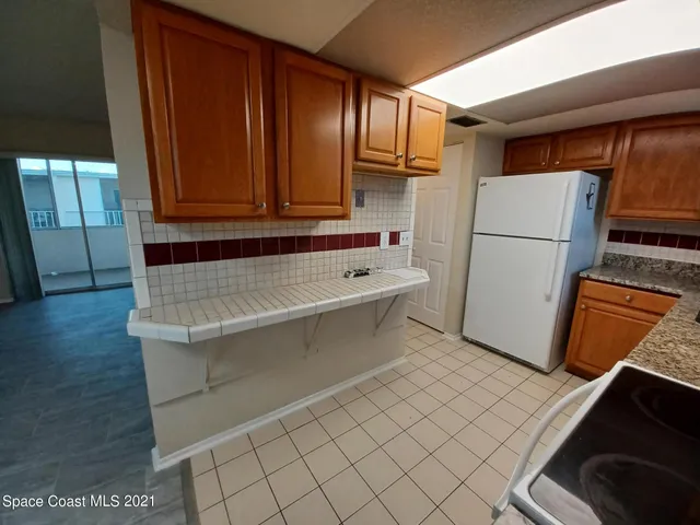 a white refrigerator freezer sitting in a kitchen