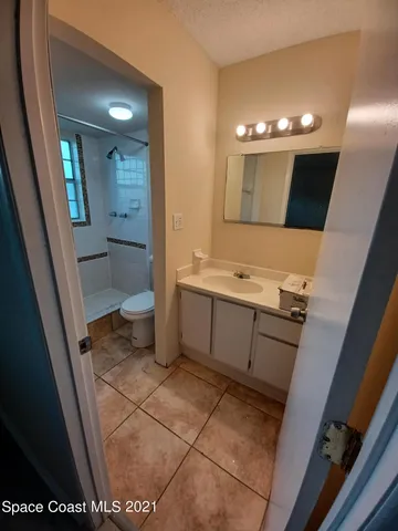 a bathroom with a sink a toilet and mirror