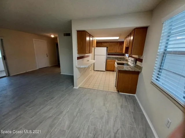 a view of a living room with wooden floor