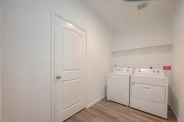 a view of storage and utility room with washer and dryer
