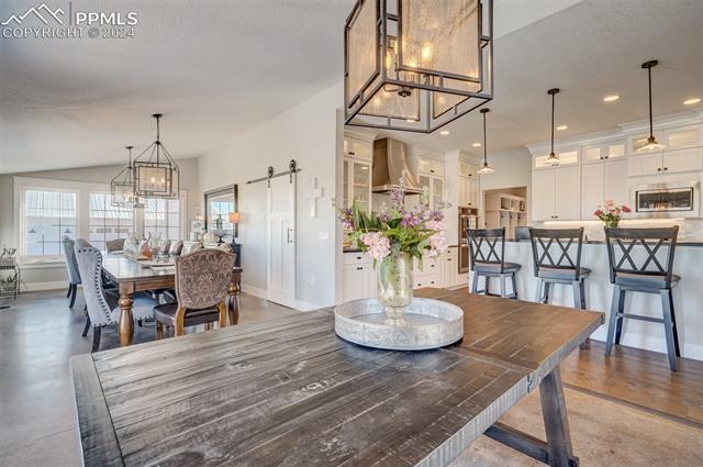 24076 Kobilan Road Calhan, CO 80808 - Photo 15 of 50 Dining space featuring a textured ceiling and a barn door