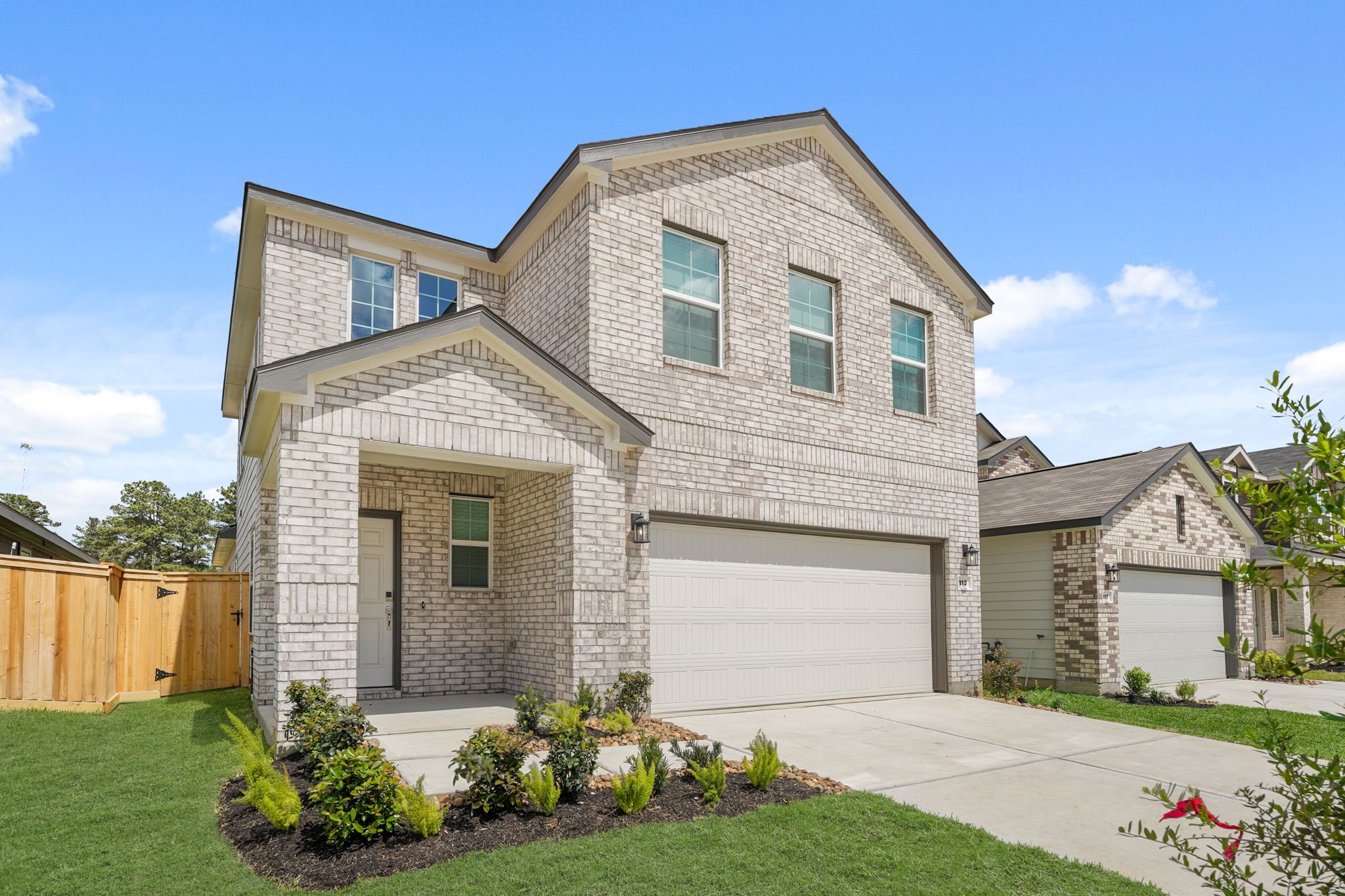 113 Rising Cedar Lane Hockley, TX 77447 - Photo 2 of 27 a front view of a house with a yard and garage