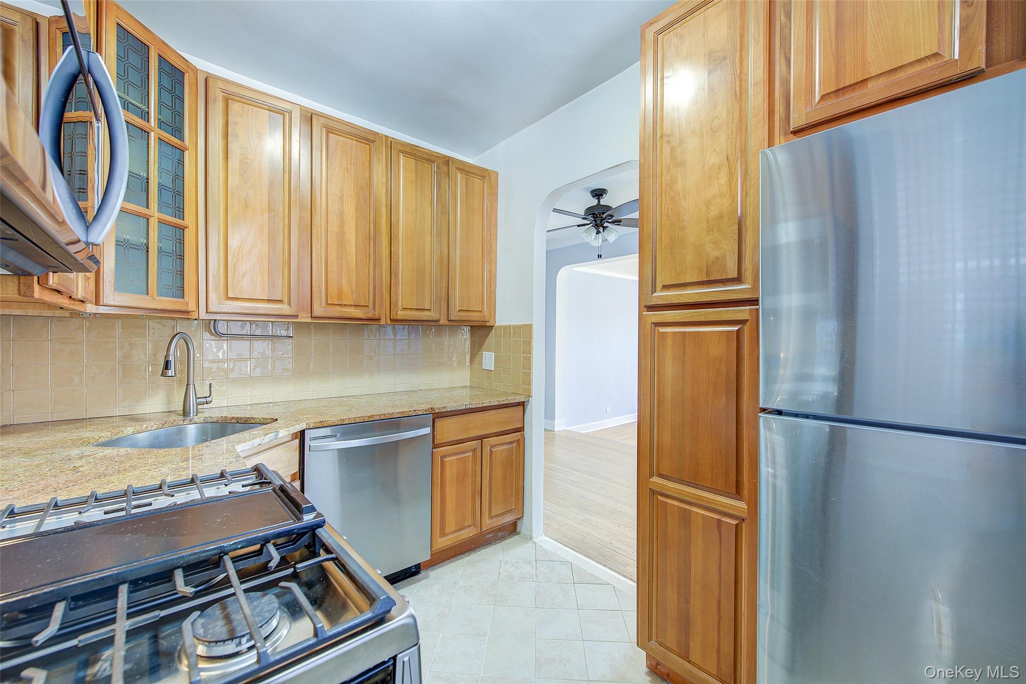 77-14 113th Street, Unit 4S Queens, NY 11375 - Photo 15 of 40 a kitchen with stainless steel appliances granite countertop a refrigerator and a sink