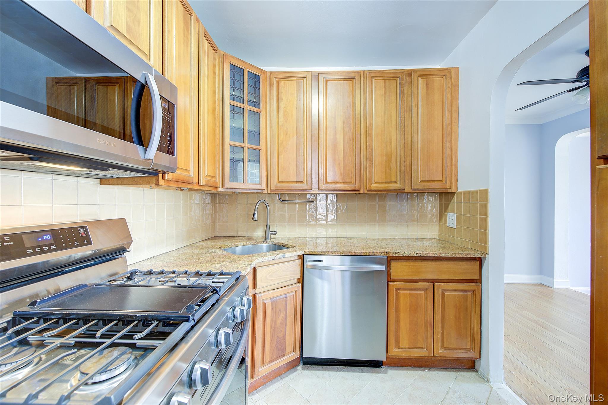 77-14 113th Street, Unit 4S Queens, NY 11375 - Photo 16 of 40 a kitchen with stainless steel appliances granite countertop a stove and a sink
