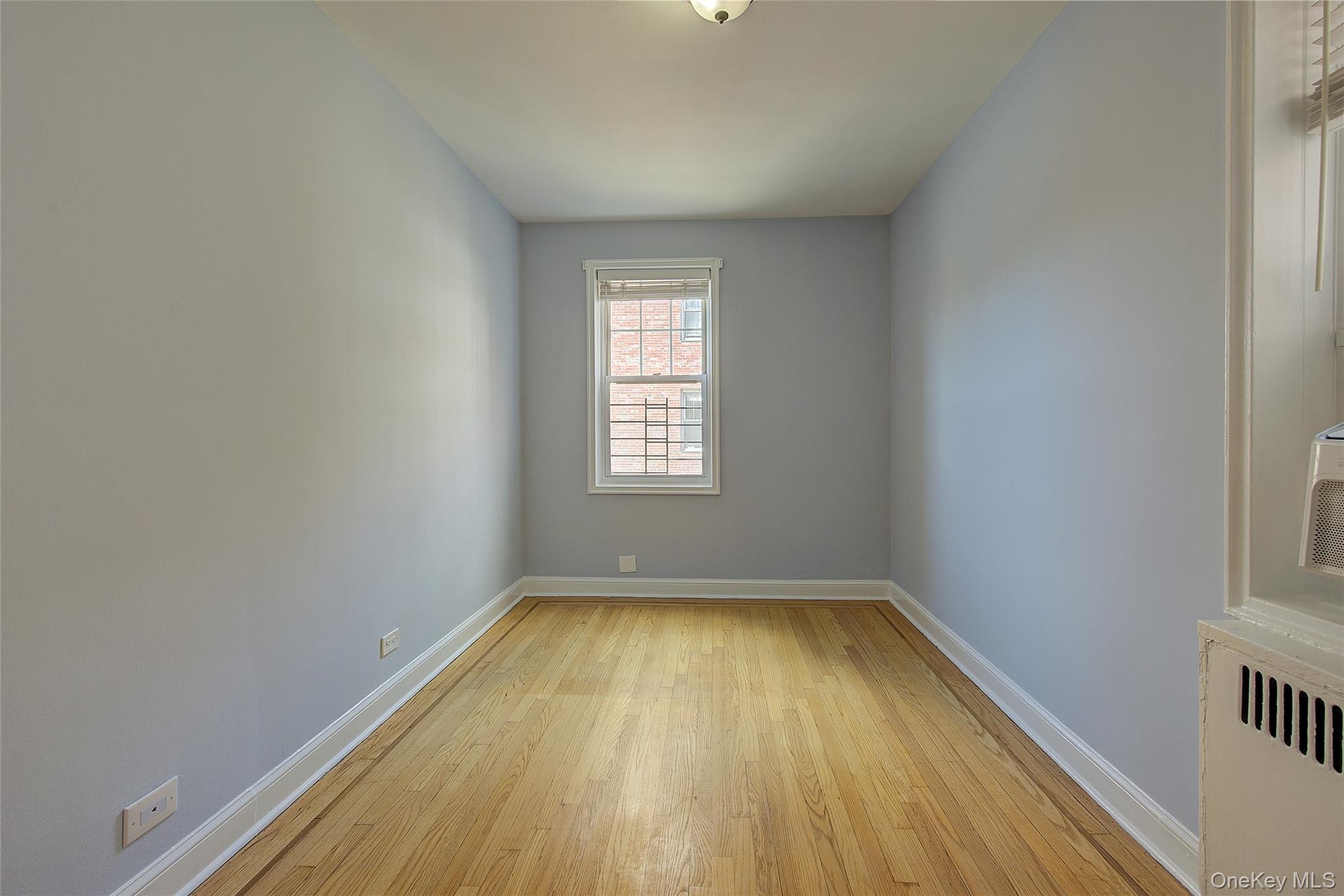77-14 113th Street, Unit 4S Queens, NY 11375 - Photo 24 of 40 a view of a room with wooden floor and window